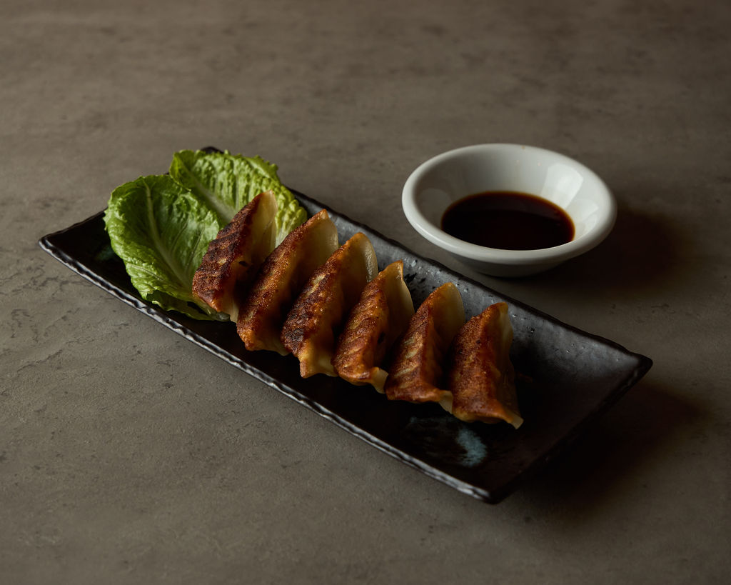Golden gyoza dumplings in a cast iron pan